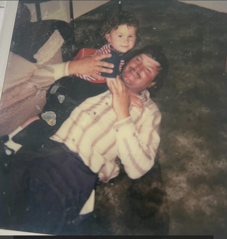 The founder as a young child, sitting on his dad's shoulders, both smiling